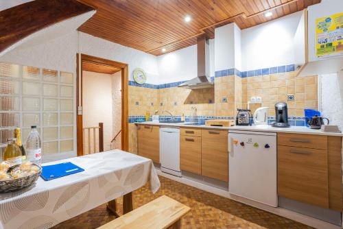 a kitchen with a table and a counter top at Au Petit Paris, Centre de Céret in Céret