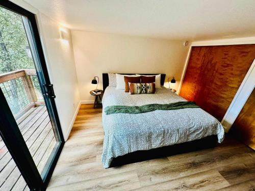 a bedroom with a bed and a balcony at The Falls-Overlooks a waterfall-BBQ-Sleeps 4 in Oakhurst
