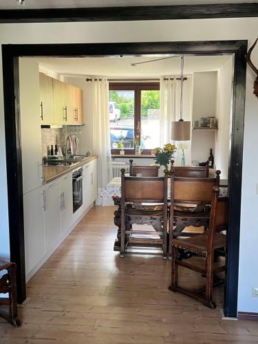 a kitchen with a table and chairs in it at Haus am Waldrand in Todtmoos