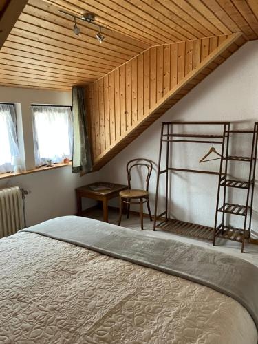 a bedroom with a bed and a wooden ceiling at Haus am Waldrand in Todtmoos