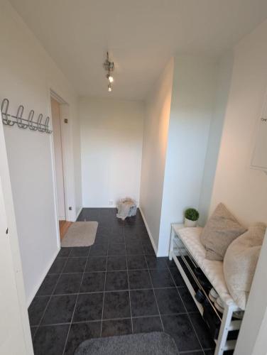 a hallway with a couch in a room at Cozy apartment in Tromsø