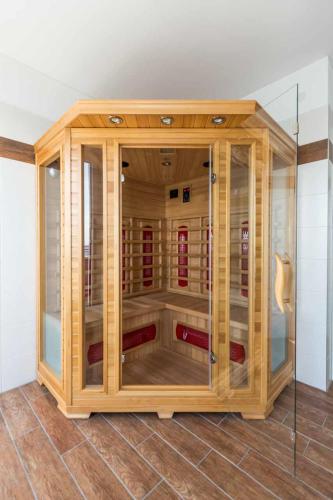 a wooden cabinet with glass doors in a room at Ferienhaus Wellenreiter in Kappeln