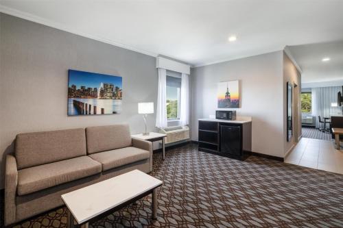 a living room with a couch and a table at Best Western Premier NYC Gateway Hotel in North Bergen