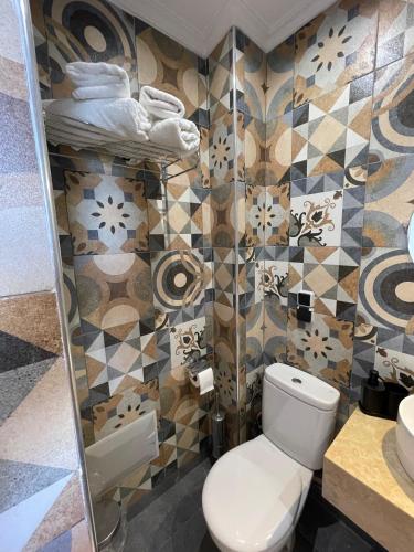 a bathroom with a toilet and a sink at Diaft'na in Marrakech
