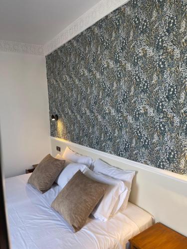 a bed with two pillows on it in a bedroom at Diaft'na in Marrakech