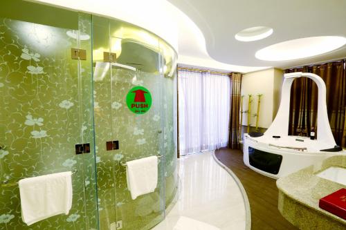 a bathroom with a shower and a sink at Holiday One Can Tho Hotel in Can Tho