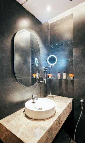 a bathroom with a sink and a mirror at Galaxy blue sapphire plaza in Ghaziabad