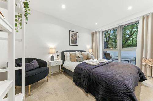 a bedroom with a bed and a chair and a window at Springfield Two in Harrogate