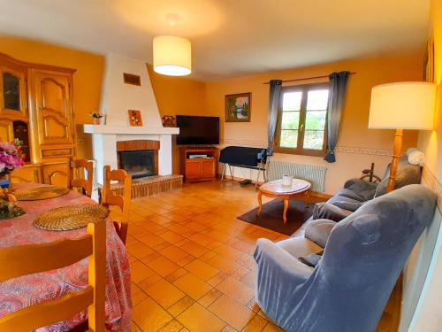 a living room with a couch and a fireplace at L'Evasion, maison spacieuse, véranda, parking in Saint-André-de-Cubzac