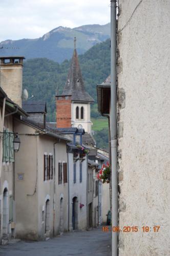 an alley in a town with a church in the background at Gite Cap de la Hont in Laruns