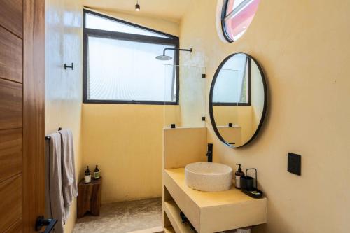 a bathroom with a sink and a mirror at CALIXTO Villa 4 in Bucerías