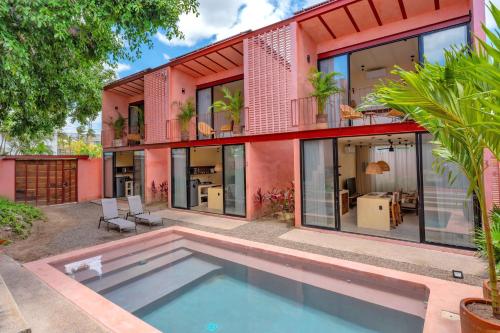 a house with a swimming pool in front of it at CALIXTO Villa 4 in Bucerías