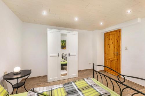 a room with a bed and a table and a door at Ferienwohnungen Zum Hasenbahnhof in Kirchhundem