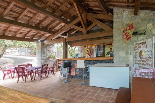 a patio with a table and chairs and a fireplace at Camping Midi - mobil home 6-8 pers in Vallon-Pont-dʼArc