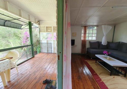 a living room with a couch and a table at Kitengela Cabin in Kajiado