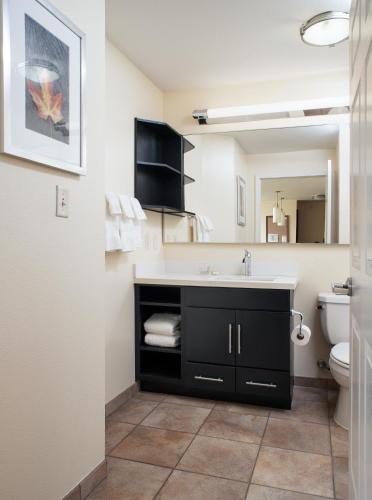 a bathroom with a sink and a toilet at Candlewood Suites Bellevue by IHG in Bellevue