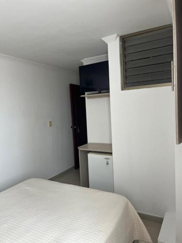 a small bedroom with a bed and a window at HOTEL COSTA DEL SOL FUSAGASUGa in Fusagasuga