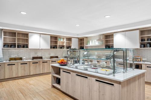 a large kitchen with wooden cabinets and a large island at Hyatt House Orlando International Drive in Orlando