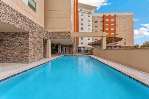 a swimming pool in the courtyard of a building at Hyatt House Orlando International Drive in Orlando