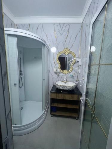 a bathroom with a sink and a mirror at Old town guest house in Bukhara