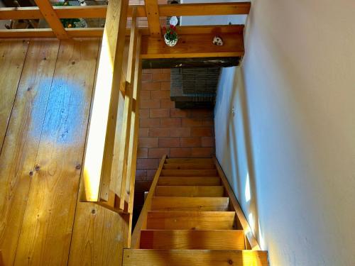 an overhead view of a wooden staircase in a house at La Loggetta dei Poderi - 5' dalle Terme di Saturnia in Montemerano
