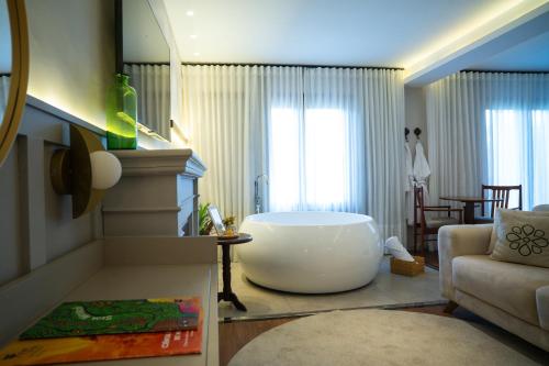 a bathroom with a large tub in the middle of a room at Natureza Eco Lodge in Pedra Azul