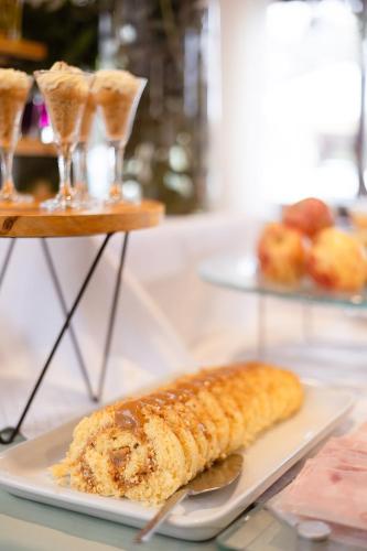 a plate of food with a corn on a table at Vila Suzana Parque Hotel in Canela