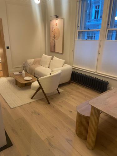 a living room with a couch and a table at 30a Willesden in London