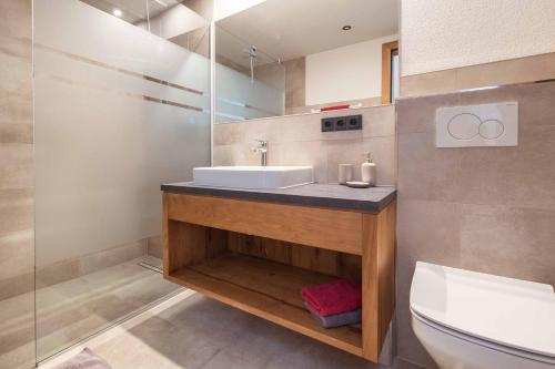 a bathroom with a sink and a toilet at Appartement Pension Strolz in Bichlbach
