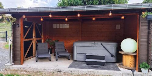 a garage with two chairs and a grill at Le Rensy in Ferrières