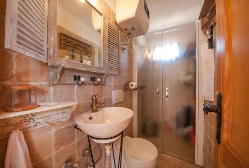 a bathroom with a sink and a toilet and a shower at Holiday Home Queen of Kornati in Vrulje