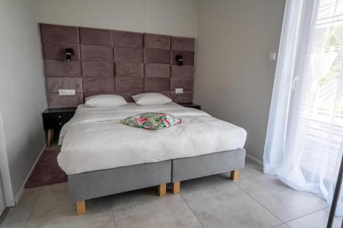 a bedroom with a bed with a pillow on it at domki Koziniec na wyłączność Myczkowce Solina Bieszczady 5 in Myczkowce