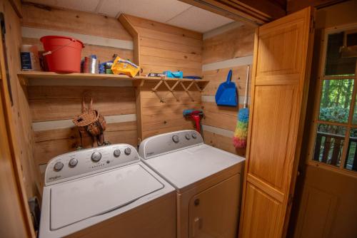 a small kitchen with a stove in a tiny house at Fleetwood Falls Cabin near Boone- Community River & Lake Access, Dogs OK in Fleetwood