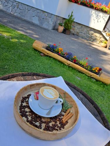 a cup of coffee on a plate on a table at Penzión Encián in Tatranská Lomnica