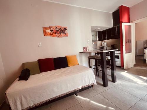 a living room with a bed and a kitchen at Colorado in Mendoza