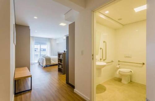 ein Bad mit WC und ein Bett in einem Zimmer in der Unterkunft BHomy Apm in São Paulo