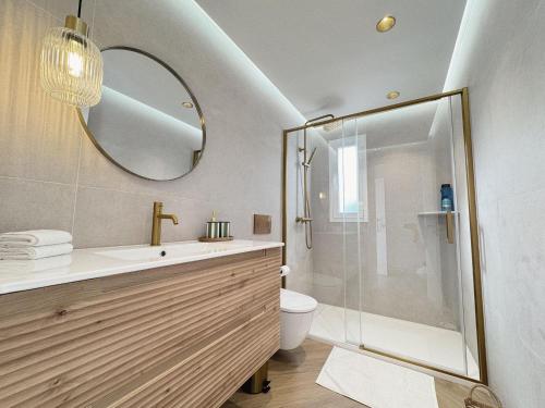 a bathroom with a shower and a sink and a mirror at Golf y Playa in Roquetas de Mar