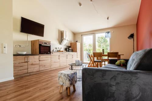a living room with a couch and a kitchen at Sonnenscheinhaus Wohnung 4 in Erbach im Odenwald