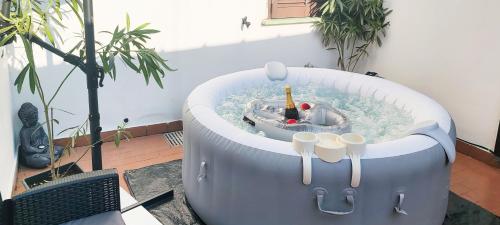 a bathtub in a courtyard with a pool of water at Zen Retreat with Jacuzzi, Patio & Private Garage Plus Automatic Check in 24 7 with Netflix Dazn and Disney Plus in Casale Monferrato