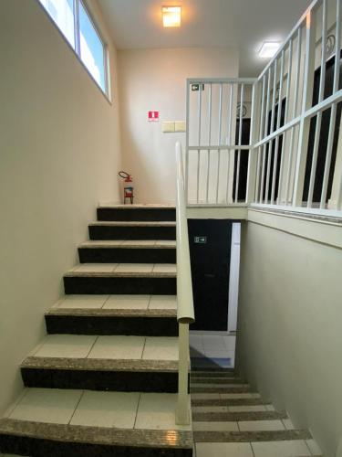 a staircase in a building with a stair case at Arwanã Beach - Pousada e Hostel in Fortaleza