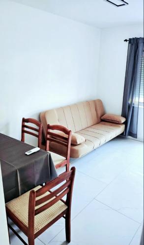 a living room with a couch and two chairs at Apartmani Bradaric Hvar in Gdinj