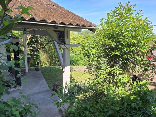 a gazebo in the middle of a garden at Eulalie ,maison de village avec jardin in Saint-Aulaye