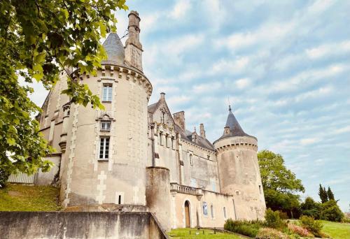 an old castle with turrets on top of a hill at Eulalie ,maison de village avec jardin in Saint-Aulaye