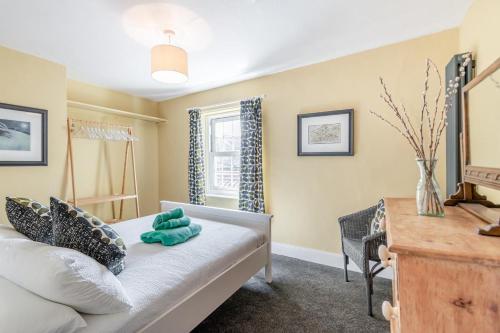 En eller flere senge i et værelse på Muriel Cottage