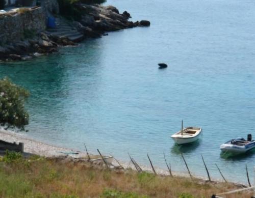 two boats are docked in the water on a beach at Apartmani Bradaric Hvar in Gdinj