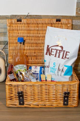 a basket filled with food and a bottle of ketchup at The Maltings in Ludham