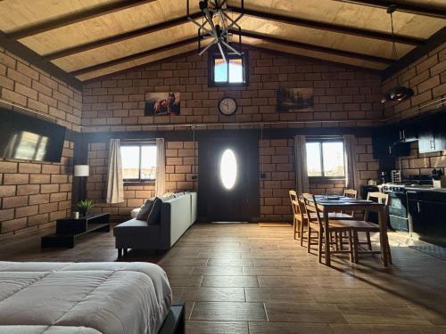a bedroom with a bed and a table and chairs at HOTEL & RV PARK ROSA EVELYN in San Quintín