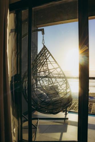 a metal basket hanging from a window in a room at Austral Suítes à Beira-Mar in Imbituba