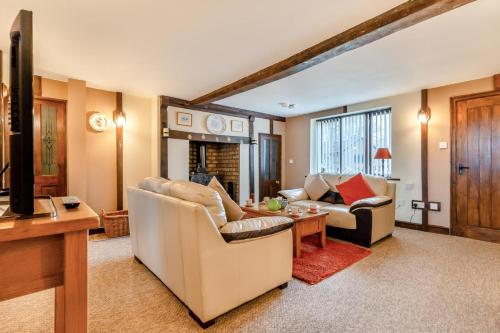 a living room with a couch and a table at Grange Farm House in Hainford
