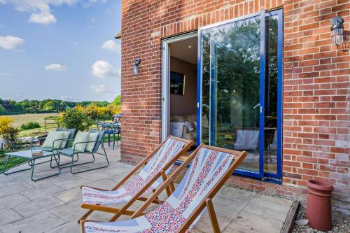 a group of chairs sitting on a patio at Oak View - Holbrook in Holbrook